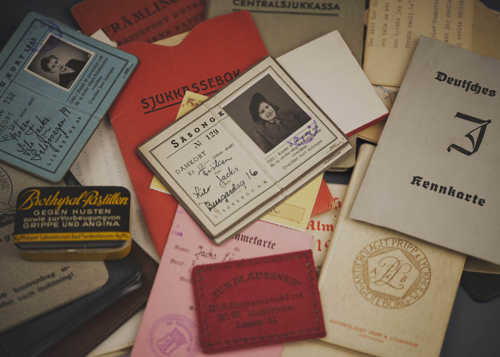 A collection of objects, including a box and various identity documents.