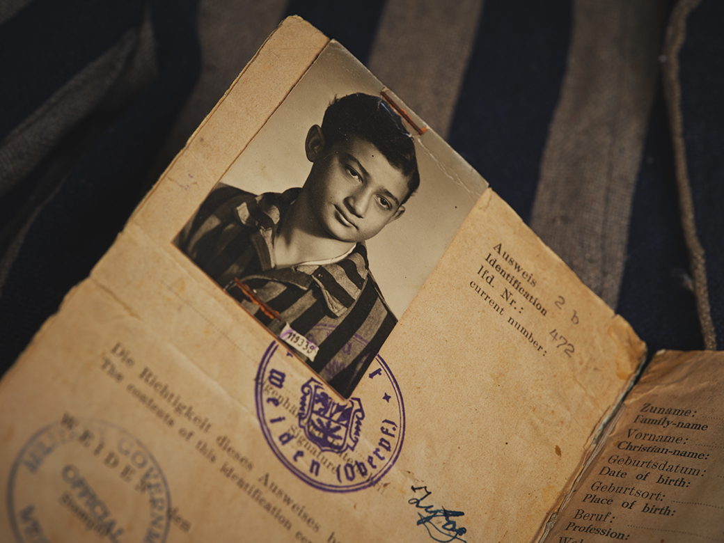 Identification document on top of a striped prison jacket.