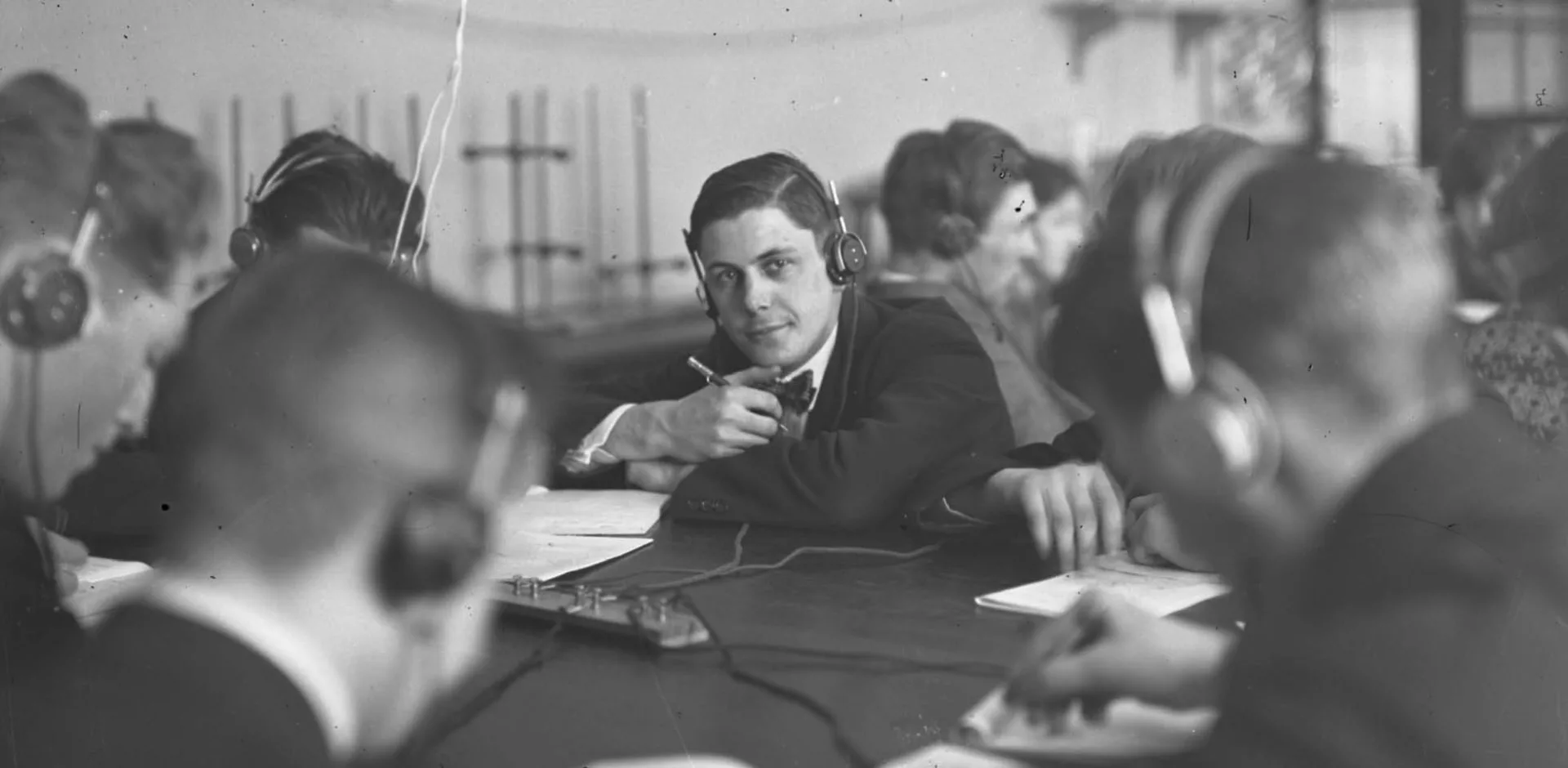 Radio broadcast, May 17, 1941. People sitting at a desk, one person looks into the camera.